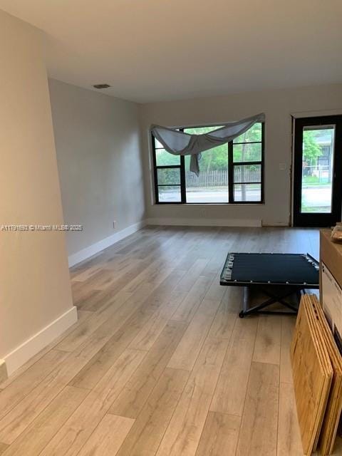 2 NE 44th St, Miami, FL 33137 - living room with plenty of natural light, light wood-style flooring, and baseboards