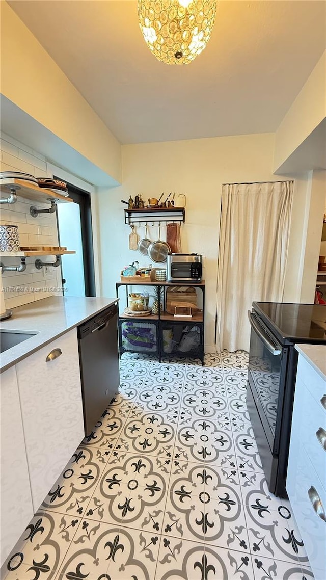 2 NE 44th St, Miami, FL 33137 - kitchen with black range with electric stovetop, light floors, stainless steel dishwasher, and light countertops