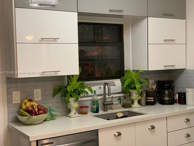 2 NE 44th St, Miami, FL 33137 - kitchen with light countertops, dishwasher, a sink, and tasteful backsplash
