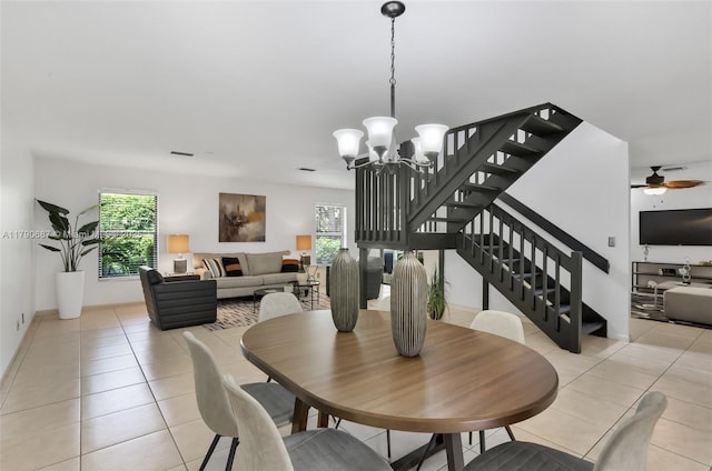 dining space with light tile patterned floors, a wealth of natural light, and stairs