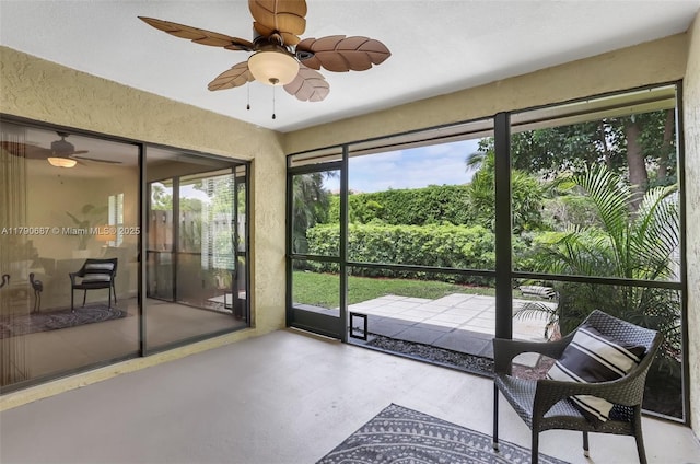 sunroom / solarium featuring a textured wall and finished concrete floors