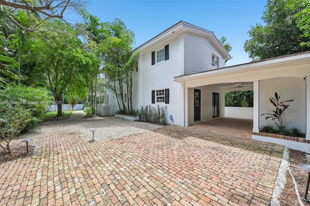4700 Alhambra Cir, Coral Gables, FL 33146 - exterior space featuring a patio area, ceiling fan, stucco siding, and fence