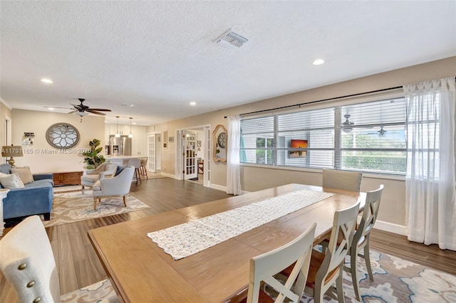 dining room with recessed lighting, ceiling fan, wood finished floors, and baseboards
