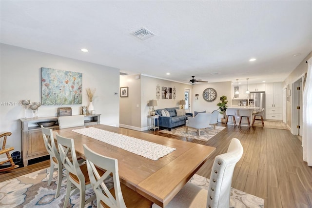 dining space featuring recessed lighting, a ceiling fan, visible vents, and light wood-type flooring