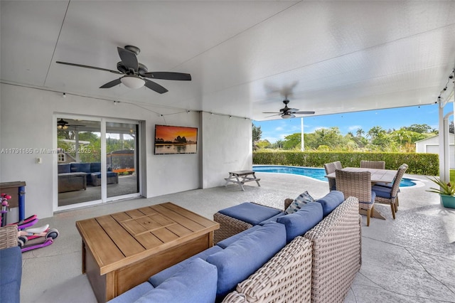 view of patio / terrace with an outdoor hangout area, outdoor dining space, a ceiling fan, and a fenced in pool