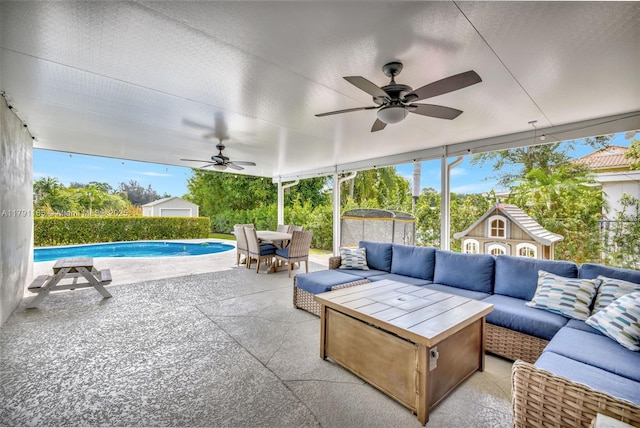 view of patio / terrace featuring an outdoor structure, a fenced in pool, outdoor dining area, ceiling fan, and an outdoor living space