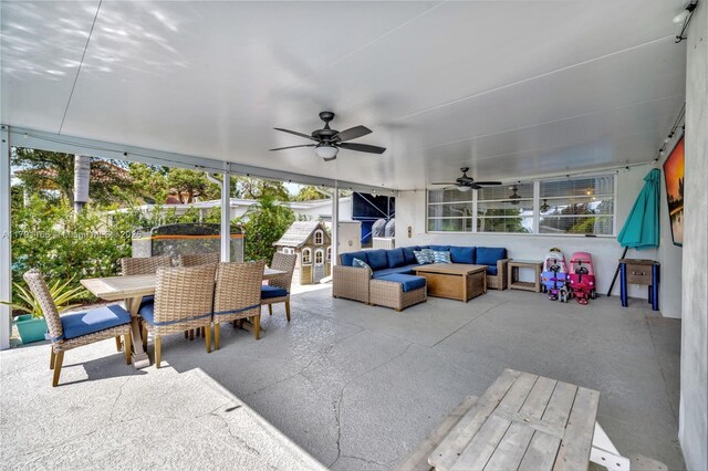 sunroom featuring a ceiling fan, an outdoor living space, and outdoor dining area