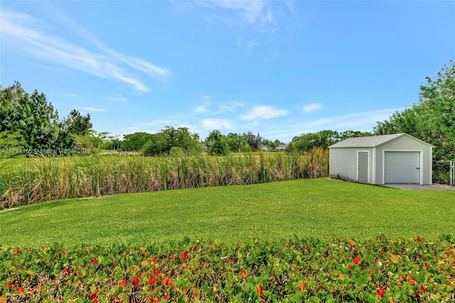 view of yard featuring a garage and an outdoor structure