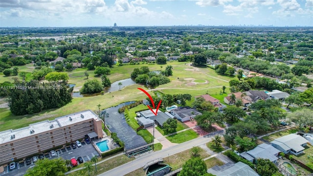 drone / aerial view featuring view of golf course and a water view