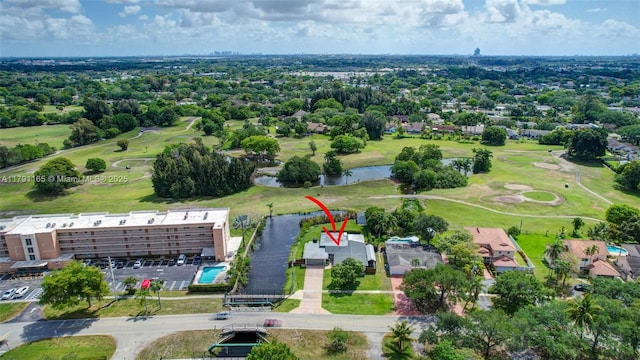 aerial view with golf course view and a water view