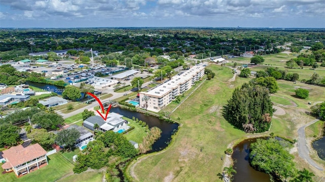 drone / aerial view featuring a water view and golf course view