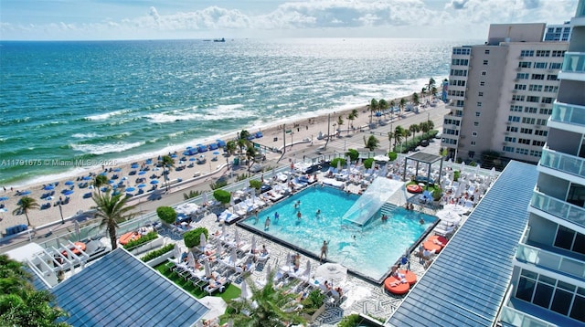 birds eye view of property with a view of the beach and a water view