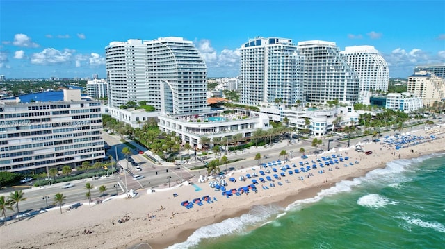 drone / aerial view with a beach view, a water view, and a view of city