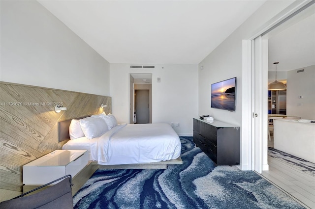 bedroom with visible vents and wood finished floors