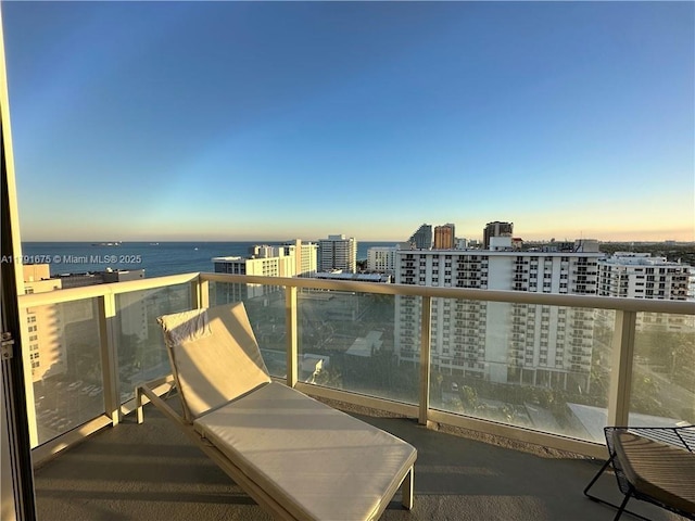 balcony with a view of city and a water view