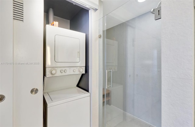 washroom featuring stacked washing maching and dryer and laundry area