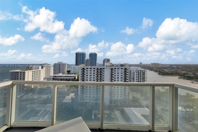 balcony with a view of city and a water view