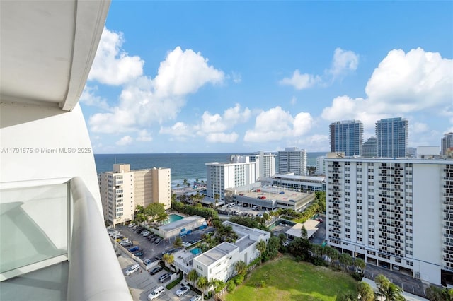 balcony featuring a water view and a city view