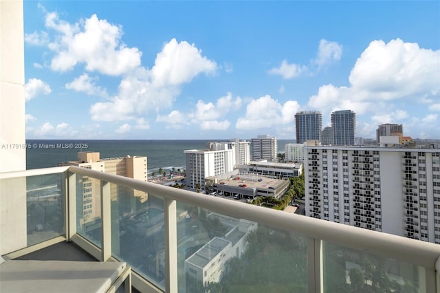 balcony with a view of city and a water view