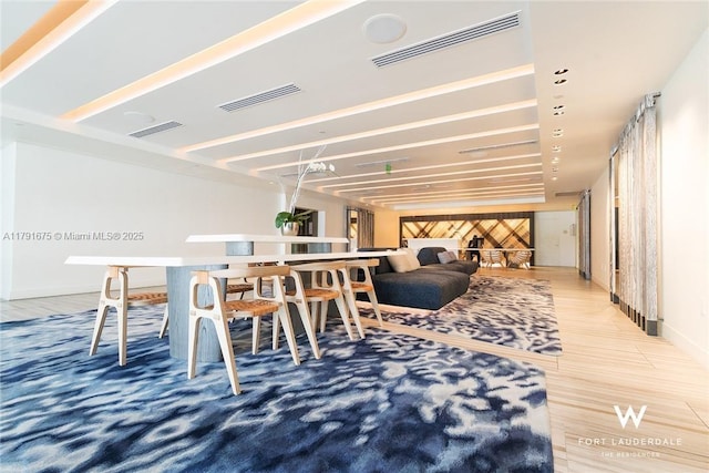 dining room with visible vents, wood finished floors, and baseboards