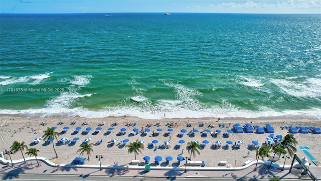 bird's eye view featuring a view of the beach and a water view
