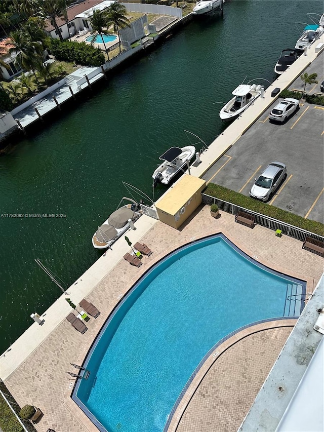 community pool featuring a water view and a patio area
