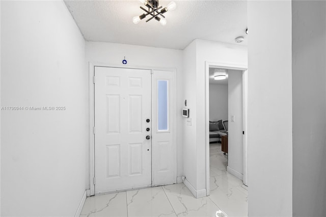 2215 SE 7th Pl, Homestead, FL 33033 - entryway with a textured ceiling, marble finish floor, and baseboards