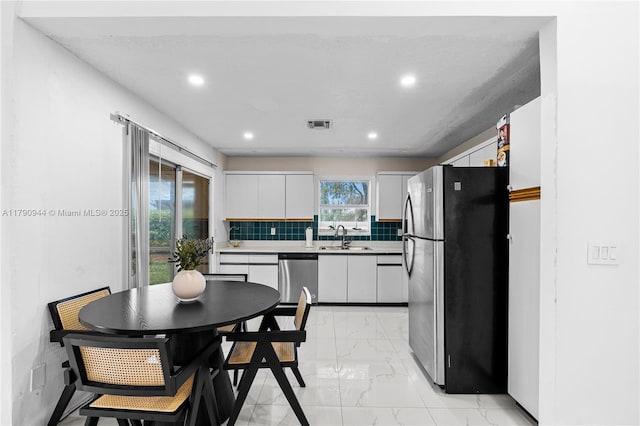 2215 SE 7th Pl, Homestead, FL 33033 - kitchen featuring recessed lighting, stainless steel appliances, marble finish floor, a sink, and white cabinetry