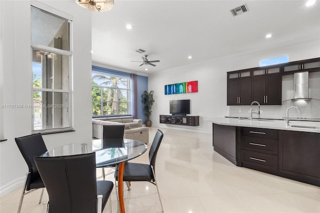 dining space featuring light tile patterned floors, visible vents, baseboards, ornamental molding, and a ceiling fan