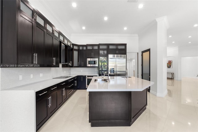 kitchen with built in appliances, light countertops, crown molding, and a sink