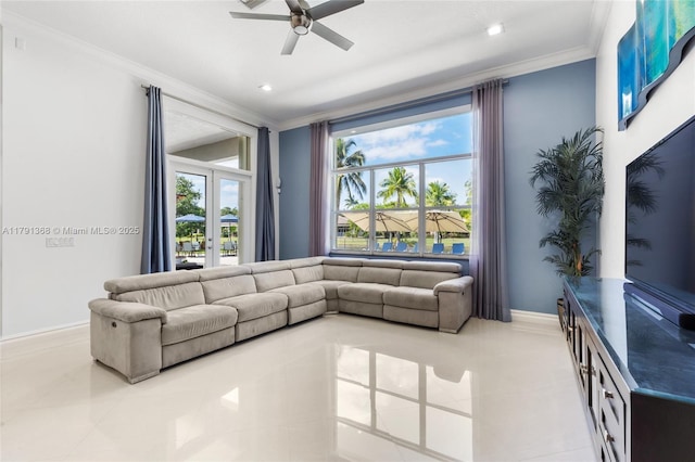 living area featuring ornamental molding, tile patterned flooring, ceiling fan, and baseboards