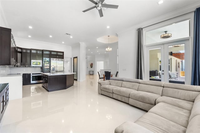 living area with crown molding, a ceiling fan, and recessed lighting