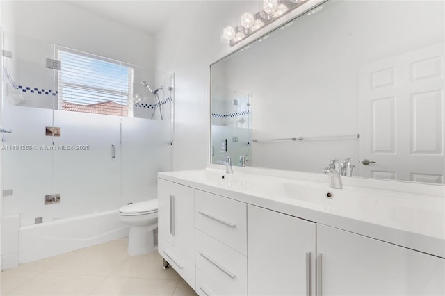bathroom featuring a sink, shower / bathing tub combination, toilet, double vanity, and tile patterned flooring