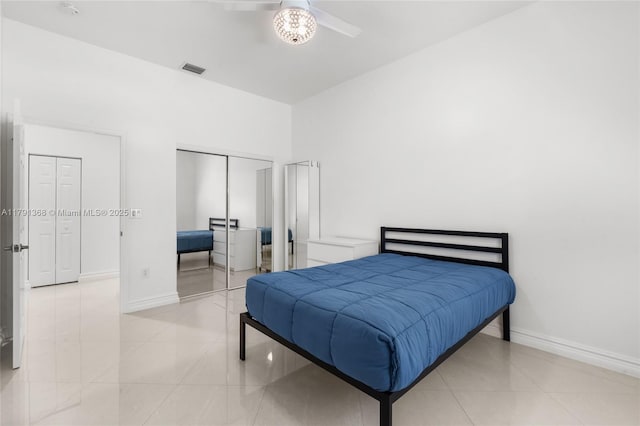tiled bedroom featuring visible vents, a closet, and baseboards