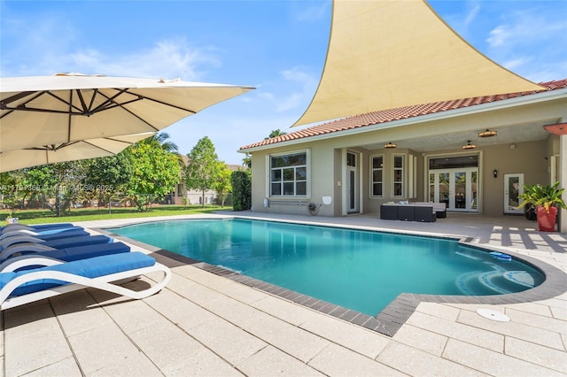 outdoor pool featuring fence, a patio, and french doors