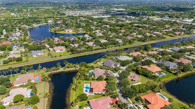 drone / aerial view with a residential view and a water view