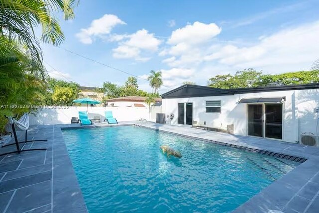 view of pool featuring a fenced backyard, a fenced in pool, and a patio area