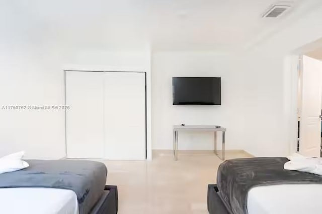 bedroom featuring visible vents and a closet
