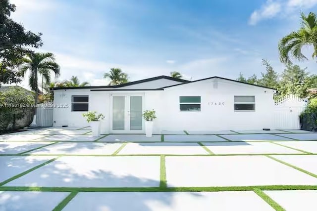 back of house with fence and stucco siding