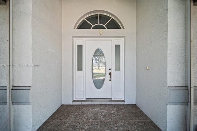 property entrance featuring stucco siding