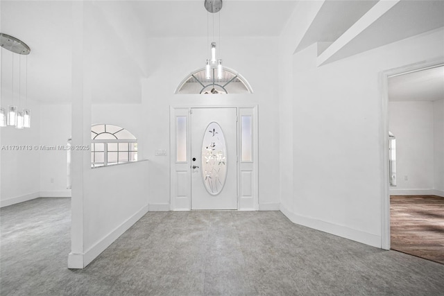 carpeted entryway featuring baseboards