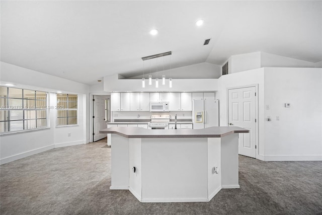 kitchen featuring a sink, carpet floors, a center island with sink, white appliances, and lofted ceiling