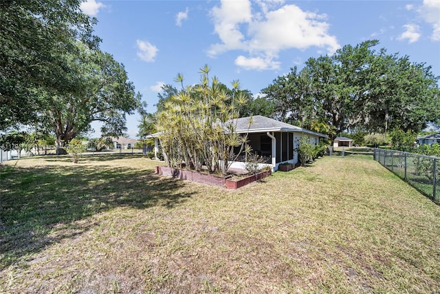 view of yard featuring a fenced backyard and a sunroom
