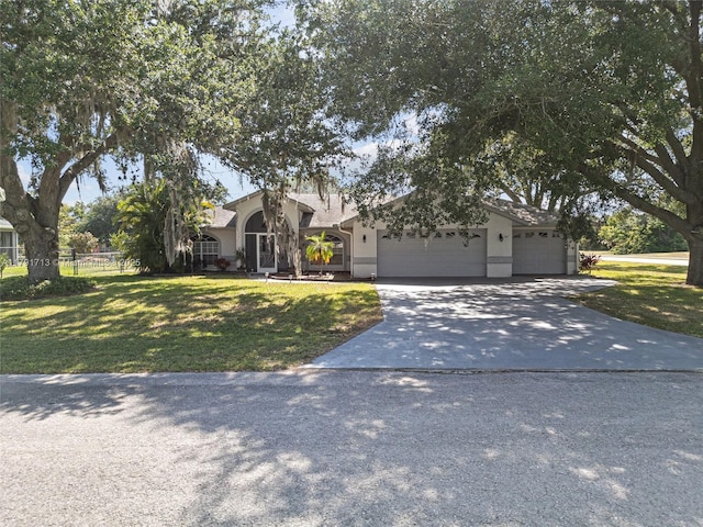 mid-century inspired home with fence, a front yard, driveway, and an attached garage