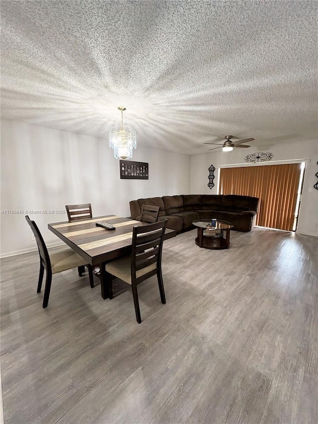 2091 Coral Ridge Dr Unit N306, Coral Springs, FL 33071 - dining room featuring baseboards, a textured ceiling, ceiling fan with notable chandelier, and wood finished floors