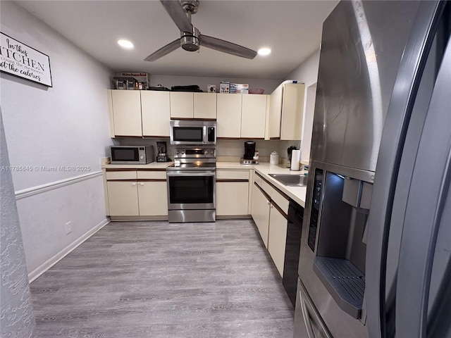 2091 Coral Ridge Dr Unit N306, Coral Springs, FL 33071 - kitchen featuring light wood-style floors, ceiling fan, light countertops, a sink, and appliances with stainless steel finishes