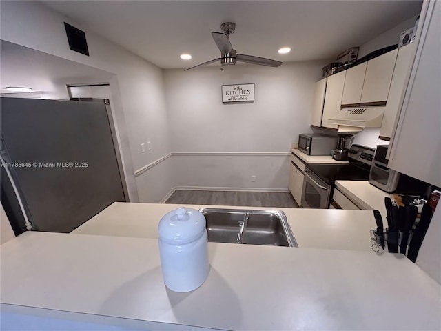 kitchen with recessed lighting, stainless steel appliances, light countertops, white cabinets, and ceiling fan