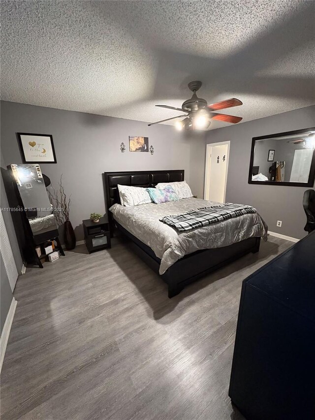 2091 Coral Ridge Dr Unit N306, Coral Springs, FL 33071 - bedroom with wood finished floors, a textured ceiling, and a ceiling fan