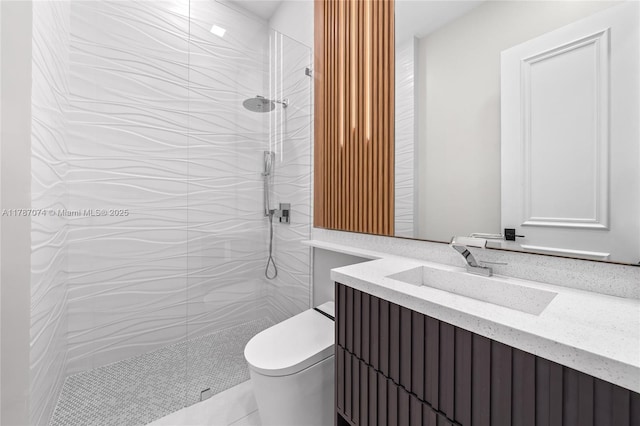 full bathroom featuring a walk in shower, vanity, and toilet