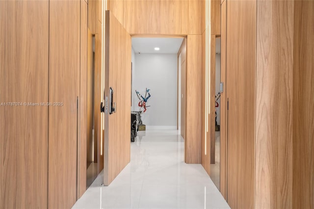 hall with tile patterned floors